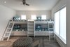 Modern home with Bed, Undermount Sink, Ceiling Lighting, Engineered Quartz Counter, Freestanding Tub, Enclosed Shower, White Cabinet, Wood Cabinet, Travertine Floor, Back Yard, Plunge Pools, Tubs, Shower, Concrete Pools, Tubs, Shower, Large Patio, Porch, Deck, Decking Patio, Porch, Deck, Horizontal Fences, Wall, Metal Fences, Wall, Chair, Sofa, Coffee Tables, and Wood Tread. Bunk room Photo 13 of NJPV