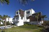 Modern home with Ceiling Lighting, Bed, Dark Hardwood Floor, Engineered Quartz Counter, Undermount Sink, Freestanding Tub, Enclosed Shower, and Outdoor. Street view of the house from Historic A1A Photo 4 of NJPV