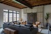 Modern home with Living Room, Chair, Sectional, Ottomans, Ceiling Lighting, Accent Lighting, and Concrete Floor. Great Room Photo 9 of HoF