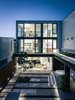 Modern home with Outdoor, Back Yard, Trees, Shrubs, Raised Planters, Pavers Patio, Porch, Deck, Decking Patio, Porch, Deck, Walkways, Stone Patio, Porch, Deck, Vertical Fences, Wall, and Landscape Lighting. Rear Yard & Facade Photo 18 of Butterfly House