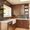 Modern home with Kitchen, Marble Counter, Wood Cabinet, and Ceramic Tile Backsplashe. Walnut + gunmetal: Our goal was to be bold but not cold. Handmade tile adds a humane touch. Richly textured walnut cabinetry and pulls add warmth.
For more info, go to: https://www.howellsarc.com/projects/holly-magda/ Photo 2 of Holly + Magda