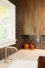 Modern home with Kitchen, Granite Counter, Ceramic Tile Backsplashe, and Wood Cabinet. Walnut + gunmetal: Our goal was to be bold but not cold. Handmade tile adds a humane touch. Richly textured walnut cabinetry and pulls add warmth.
For more info, go to: https://www.howellsarc.com/projects/holly-magda/ Photo 3 of Holly + Magda