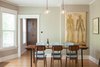 Modern home with Dining Room. The kitchen aesthetic is a counterpoint to the 1909 home. But matched oak flooring and a long-lined, elegant cabinetry scheme seek to harmonize old + new.
For more info, go to: https://www.howellsarc.com/projects/holly-magda/ Photo 5 of Holly + Magda
