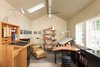 Modern home with Office, Study Room Type, Desk, Bookcase, Shelves, and Concrete Floor. Mid-way through construction, the owner decided to convert the garage into an office, as he liked it too much to give it over to parking.
For more info: https://www.howellsarc.com/projects/michael-b/ Photo 5 of Michael B
