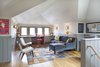 Modern home with Office, Study, Library, Lamps, Desk, Storage, Chair, and Light Hardwood Floor. We converted an old dusty attic into a spacious writer's garret. The new space involves a dormer addition that had to meet the neighborhood's strict Historic District design guidelines and blend well with the existing home—a noteworthy and unique 1914 building. Photo 4 of Writer's Garret