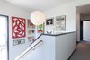 Modern home with Staircase, Wood Tread, and Wood Railing. Second story, with stairwell gallery for Dan's art collection. Photo of Dan + Jenni