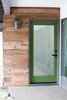 Modern home with Front Yard, Boulders, Small Patio, Porch, Deck, Hardscapes, Walkways, Stone Patio, Porch, Deck, Doors, Exterior, Wood, and Swing Door Type. A grass green front door draws from the verdant foliage blanketing the 38,000 sq. ft. hillside property. Its earthy tone complements the rich warmth of reclaimed fence wood that finds new life as siding. Photo 5 of Diablo Ranch