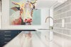 Modern home with Kitchen, Marble Counter, Colorful Cabinet, Subway Tile Backsplashe, and Porcelain Tile Backsplashe. Matte gold hardware and fixtures add a touch of luxury to balance out the colorful farmhouse art, like this oversized cow portrait. Photo 15 of Diablo Ranch