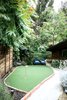 Modern home with Outdoor, Front Yard, Trees, Flowers, Shrubs, Grass, Hardscapes, Raised Planters, Walkways, Gardens, Horizontal Fences, Wall, Wood Fences, Wall, and Landscape Lighting. Instead of a traditional front yard, a playful putting green welcomes guests at the entry gate. Photo 6 of Diablo Ranch