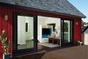 Modern home with Colorful Cabinet, Pendant Lighting, Concrete Counter, Dark Hardwood Floor, Refrigerator, Dishwasher, Cooktops, Undermount Sink, and Living Room. Large sliding glass doors connect the interiors with exterior deck Photo 3 of Lake Harriet Loft