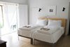 Modern home with Bedroom, Bed, Wall Lighting, and Light Hardwood Floor. high-country breezes in the master bedroom; French doors open to ranch land views Photo of PILGRIM HOUSE