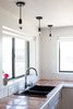 Modern home with Kitchen, Tile Counter, White Cabinet, Pendant Lighting, Drop In Sink, and Porcelain Tile Backsplashe. Hangout Lighting pendants; Grohe faucet, Kohler sink, and saltillo tile counters continue the scheme of black, white, and sun-faded earth tones throughout the house Photo 11 of PILGRIM HOUSE