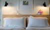 Modern home with Bedroom, Bed, Wall Lighting, and Shelves. custom-fabricated spruce headboard by Austin McLure Photo 19 of PILGRIM HOUSE