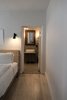 Modern home with Bath Room, Concrete Counter, Concrete Floor, Wall Lighting, Vessel Sink, and Concrete Wall. view into master bath; custom vanity; heirloom mirror; light pine floors Photo 16 of PILGRIM HOUSE