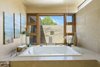 Modern home with Bath Room, Stone Counter, Whirlpool Tub, Concrete Floor, Open Shower, Floor Lighting, and Stone Tile Wall. The master bath a spa retreat include a jetted oversized tub and the ceiling faucet which fill the bathtub. Photo 5 of Santa Fe Contemporary
