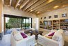 Modern home with Living Room, End Tables, Storage, Shelves, Lamps, Sofa, Coffee Tables, Ceiling Lighting, Recessed Lighting, Concrete Floor, and Wood Burning Fireplace. The living room's pocket glass Western doors recede into the wall which seamlessly incorporates indoor and outdoor living. Photo 6 of Santa Fe Contemporary