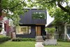 Modern home with Front Yard, Trees, Shrubs, Walkways, Concrete Patio, Porch, Deck, Casement Window Type, Exterior, House, Wood Siding Material, Metal Roof Material, and Flat RoofLine. Exterior of Pink House from the street. The entryway is recessed to enhance the spatial notion of soild and void. Photo of Pink House