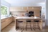 Modern home with Recessed Lighting, Wood Cabinet, Light Hardwood Floor, Pendant Lighting, Wall Oven, Casement Window Type, Kitchen, Undermount Sink, Cooktops, Range Hood, Engineered Quartz Counter, and Microwave. The custom kitchen millwork was designed by local furniture designer and manufacturer, Christian Woo. Photo 3 of Pink House