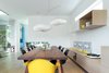 Modern home with Dining Room, Chair, Table, Shelves, Storage, Ceiling Lighting, Pendant Lighting, and Light Hardwood Floor. Dining are with custom table and millwork by Christian Woo. Photo 5 of Pink House