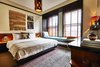 Modern home with Bedroom, Bed, Bench, Night Stands, Chair, Lamps, Wall Lighting, Pendant Lighting, and Rug Floor. The guest rooms combine artwork, textiles, and rich wood tones to provide a luxurious, cozy retreat. Photo of Freehand Los Angeles