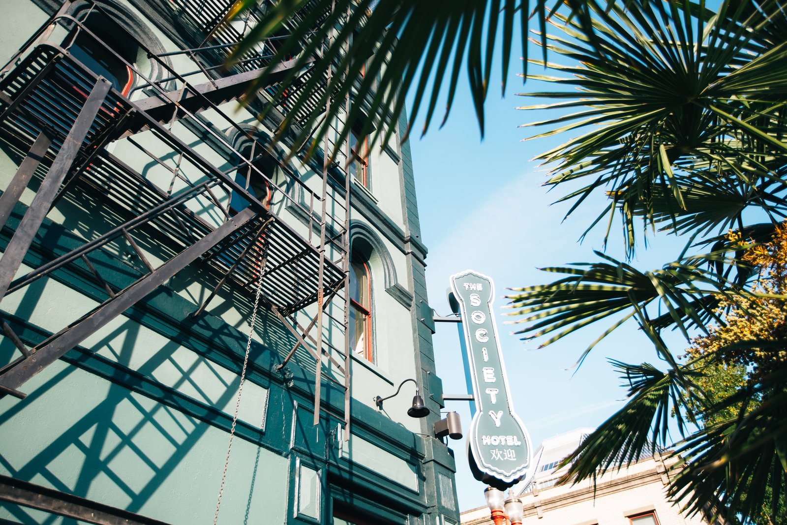 The corner of the hotel is decorated with a vintage sign.