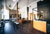Modern home with Table, Pendant Lighting, Chair, Dark Hardwood Floor, Living Room, Sofa, Wall Lighting, and Gas Burning Fireplace. The lobby of the hotel contains a cafe and lounge space complete with a fireplace. Photo 4 of The Society Hotel