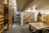 Modern home with Ceiling Lighting, Carpet Floor, Pendant Lighting, Bunks, Storage, Cabinet Storage Type, Dining Room, Chair, and Table. A hostel like bunk rooms occupies the lower level of the Hotel. Guests are provided with personal lockers and have access to a shared kitchen. Photo 6 of The Society Hotel