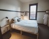 Modern home with Bedroom, Carpet Floor, Wall Lighting, Bed, Storage, and Night Stands. A variety of guest bedrooms fill the top three floors, in a configuration that closely matches the original plan of the hotel. Photo 8 of The Society Hotel