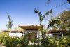 Modern home with Exterior, Cabin Building Type, and House. Each villa is composed of a series of spaces, varying from two to three bedrooms, and offers different views out to the ocean. Overlapping timber roofs made from recycled teak planks and built by local craftsman provide shade from the powerful sun. Photo 2 of Nalu Nosara