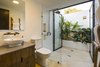 Modern home with Bath Room, Ceiling Lighting, Two Piece Toilet, Vessel Sink, and Open Shower. An outdoor shower accessed from the interior bath provides a private retreat under the sun and sky of the landscape. Photo 8 of Nalu Nosara