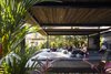 Modern home with Outdoor, Large Patio, Porch, Deck, Wood Patio, Porch, Deck, and Shrubs. The tropical modernism of the resort provides the perfect backdrop for exercise and relaxation in the Costa Rican jungle. Photo 11 of Nalu Nosara