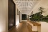 Modern home with Hallway and Medium Hardwood Floor. Slatted roofs above connecting walkways allow dappled light to fall below while framing the view out beyond. Photo 9 of Nalu Nosara