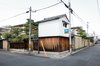 Modern home with Exterior, Wood Siding Material, House Building Type, Gable RoofLine, Stucco Siding Material, and Tile Roof Material. Nichinichi Townhouse in Kyoto, Japan Photo of Nichinichi Townhouse