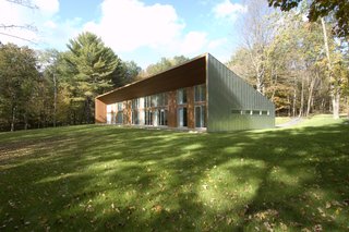 The cedar wrapped deck appears to carve out of the metal wrapped shape.