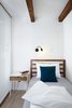 Modern home with Bedroom, Wall Lighting, Bed, Night Stands, and Light Hardwood Floor. Wooden beams, wood floors, and wood furniture pieces introduce raw elements and textures. Photo 17 of Long Story Short Hostel