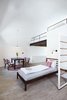 Modern home with Bedroom, Bed, Wall Lighting, and Light Hardwood Floor. The Girls Choice, 6 bed dorm is complete with a custom built mezzanine floor. Photo 11 of Long Story Short Hostel
