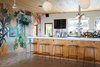 Modern home with Dining Room, Stools, Bar, Pendant Lighting, Wall Lighting, and Terrazzo Floor. The Lobby Bar serves a mix up of frozen cocktails, Japanese beer and sake, and locally grown wine. Photo 6 of The Drifter Hotel
