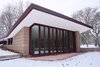 Modern home with Outdoor, Small Patio, Porch, Deck, Back Yard, Concrete Patio, Porch, Deck, and Trees. The cantilevered roofs and trim have been carefully painted and restored. Large windows blend the exterior terrace with the inside living space. Photo 3 of Frank Lloyd Wright's Eppstein House