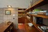 Modern home with Storage Room and Shelves Storage Type. Built-in shelving full of architecture and design books extend from the dining space to the kitchen. Photo 7 of Frank Lloyd Wright's Eppstein House