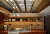 Modern home with Kitchen, Concrete Backsplashe, Track Lighting, Drop In Sink, and Open Cabinet. Open shelving continues into the kitchen. A wood-framed skylight above draws natural light into the space. Photo 8 of Frank Lloyd Wright's Eppstein House