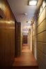 Modern home with Hallway and Concrete Floor. Refinished concrete floors extend down the Gallery corridor. Perforated concrete blocks act as transom windows to fill the corridor with light. Mahogany woodwork and doors lead to the sleeping spaces. Photo 10 of Frank Lloyd Wright's Eppstein House