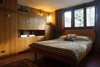 Modern home with Bedroom, Bed, Concrete Floor, Storage, Dresser, Rug Floor, and Wall Lighting. Built-in millwork provides ample storage in the bedroom spaces. Danish teak beds with mid-century textiles resemble the original furnishings. Photo 11 of Frank Lloyd Wright's Eppstein House