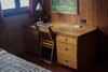 Modern home with Bedroom, Chair, Table Lighting, Concrete Floor, Storage, and Bed. A vintage writer's desk and chair fill the corner of the bedroom. Photo 12 of Frank Lloyd Wright's Eppstein House
