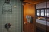 Modern home with Bath Room, Enclosed Shower, and Subway Tile Wall. Unsold tiles from the 1950's were sourced from Battle Creek Tiles & Mosaic. The vintage tiles maintain the original character of the home in the renovated baths. Photo 13 of Frank Lloyd Wright's Eppstein House