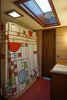 Modern home with Bath Room, Freestanding Tub, Wood Counter, Concrete Floor, Ceiling Lighting, Full Shower, Vessel Sink, and Drop In Sink. A large, wood framed skylight fills the master bath with daylight. A Frank Lloyd Wright inspired shower curtain accents the remodeled bath. Photo 14 of Frank Lloyd Wright's Eppstein House