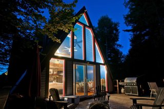 A cozy A-frame with views of Whiteface Mountain, this dwelling features a living room, fireplace, loft bedroom, and fully equipped kitchen. 