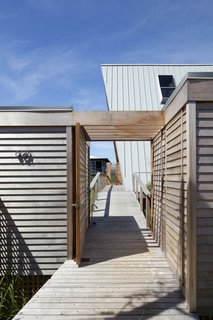 A wood promenade connects the beachside retreat directly to the bay.