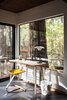 Modern home with Office, Chair, Lamps, and Desk. Large windows and sliding glass doors provide a direct connection to the outdoors. Photo 5 of MiniMod Cabin