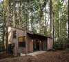 Modern home with Exterior, House Building Type, Cabin Building Type, Shed RoofLine, and Wood Siding Material. The wood exterior blends in quietly with the surrounding timber. Photo of MiniMod Cabin