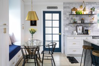 The newly expanded laundry room is accessible via a blue door, directly adjacent to the kitchen and dining spaces.
